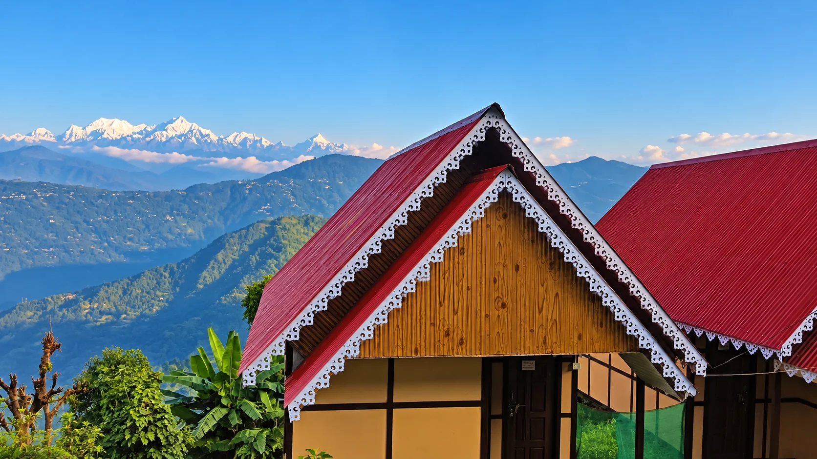 The homestay’s timber front and red roof, with a mountain ridge behind